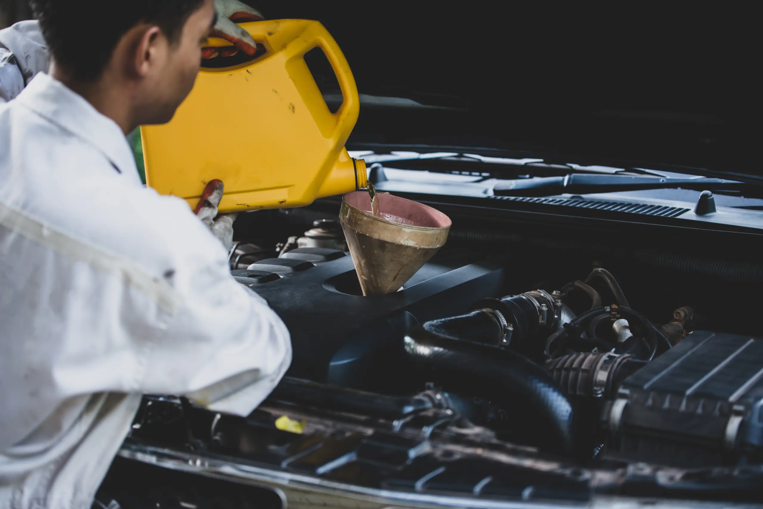 close-up-auto-mechanic-hand-pouring-replacing-fresh-oil-into-car-engine-auto-repair-garage-automobile-maintenance-industry-concept