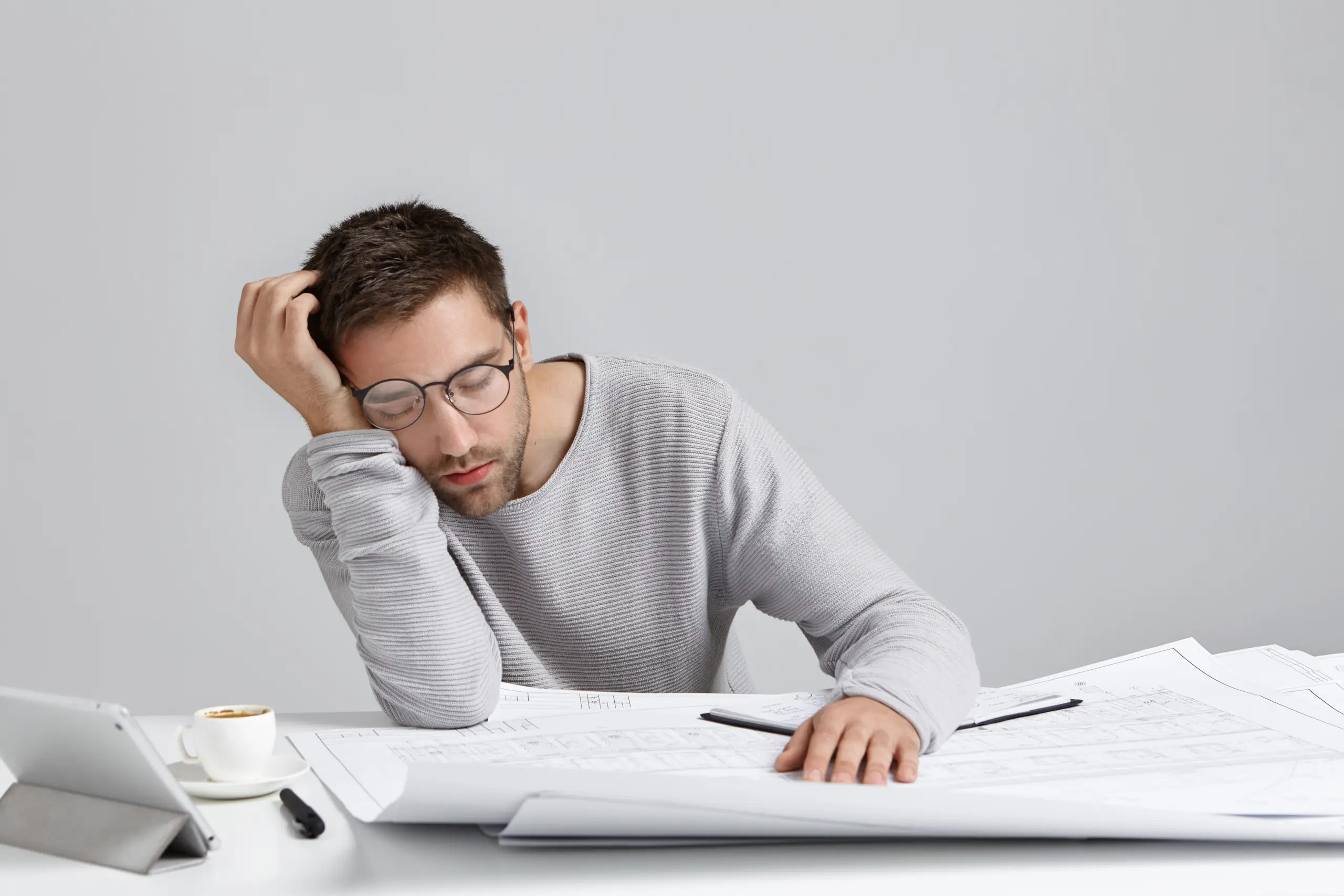 tired-young-attractive-man-sleeps-work-place-has-much-work-being-fatigue-exhausted