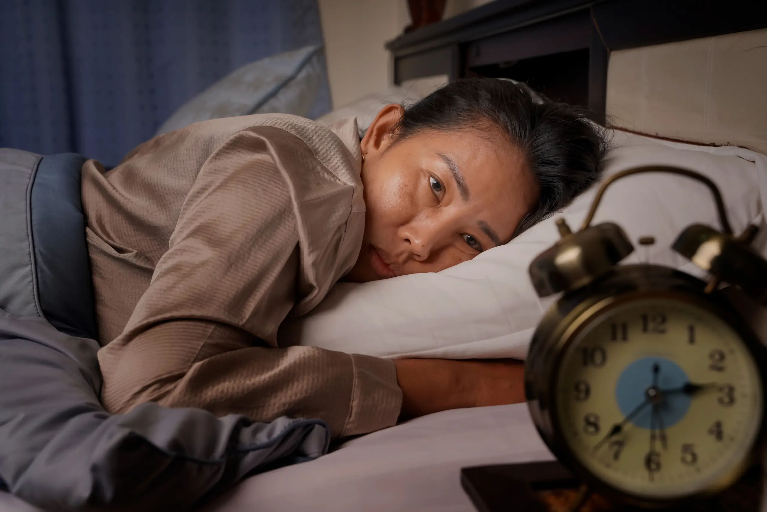 middle-aged-woman-depressed-stressed-lying-bed-looking-clock-from-insomnia