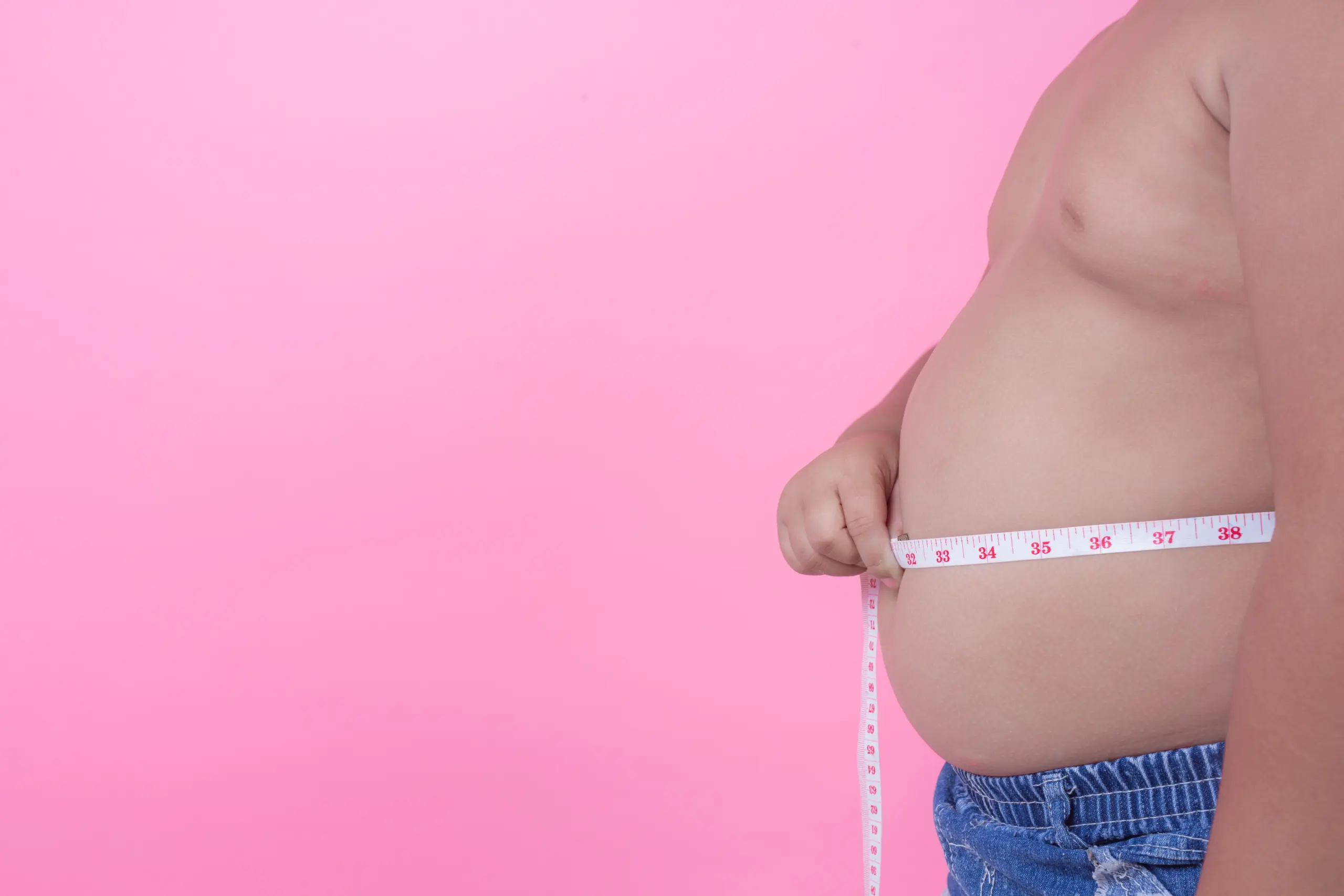 obese-boy-who-is-overweight-pink-background
