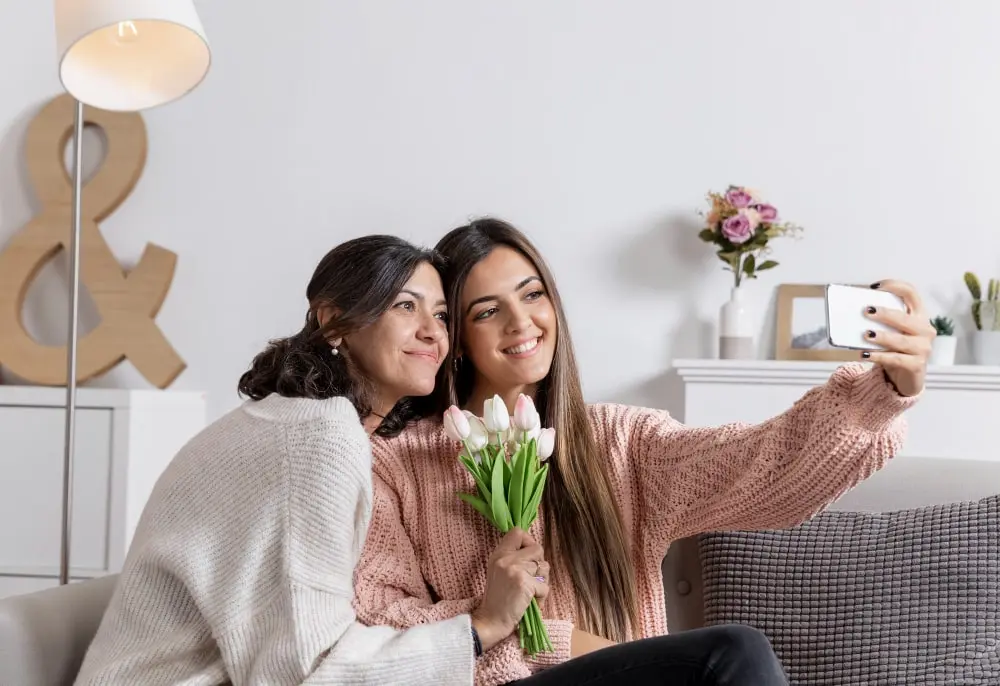 mother-daughter-home-taking-selfie-min